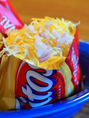 Frito pie in a Fritos bag topped with onions