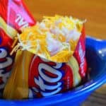 Frito pie in a Fritos bag topped with onions
