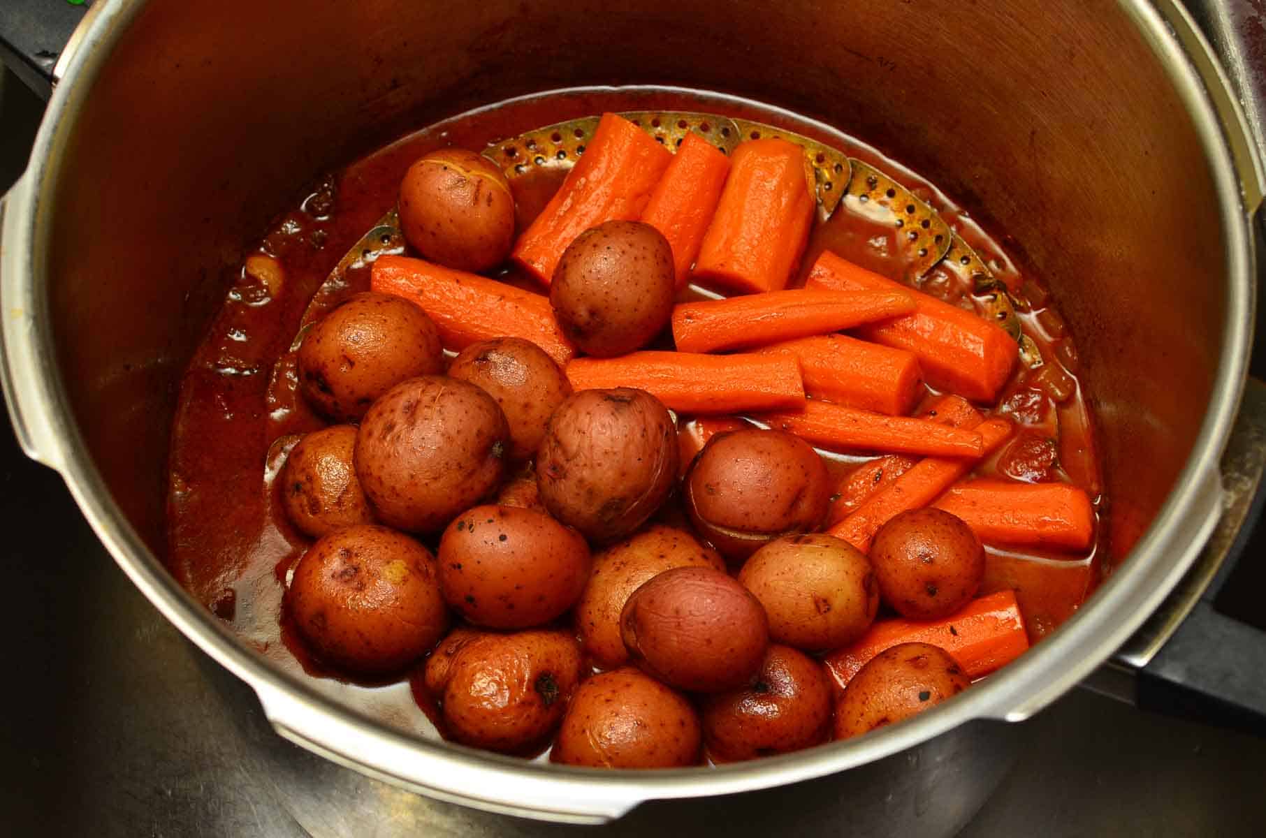 Potatoes and carrots on the vegetable steamer