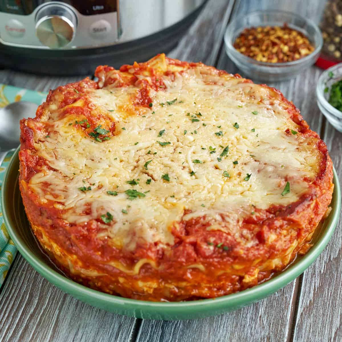 Instant Pot Lasagna on a plate with spices in the background