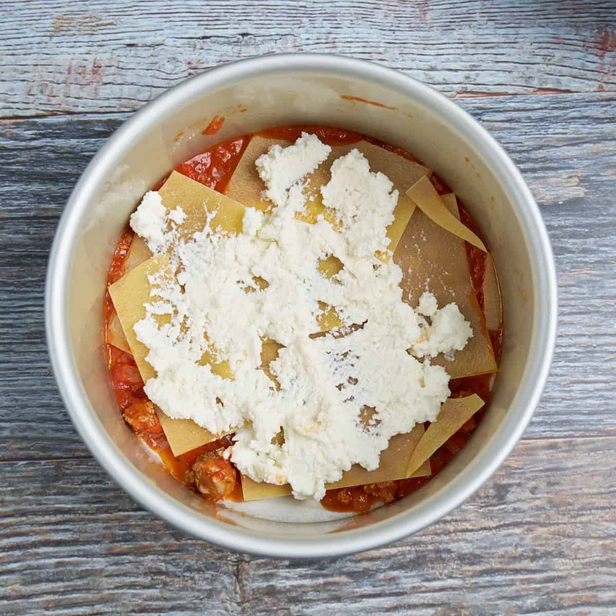 Step 2 - spread ⅓ of the ricotta on the noodles