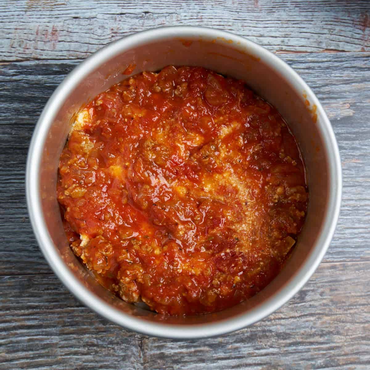 Step 3 - Spread ½ cup of sauce over the ricotta