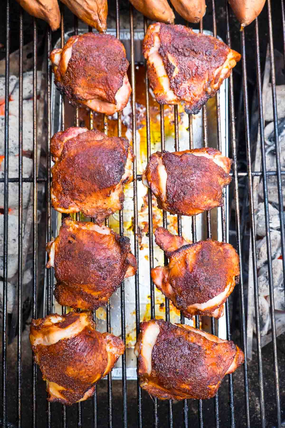 BBQ Chicken thighs cooking over indirect heat