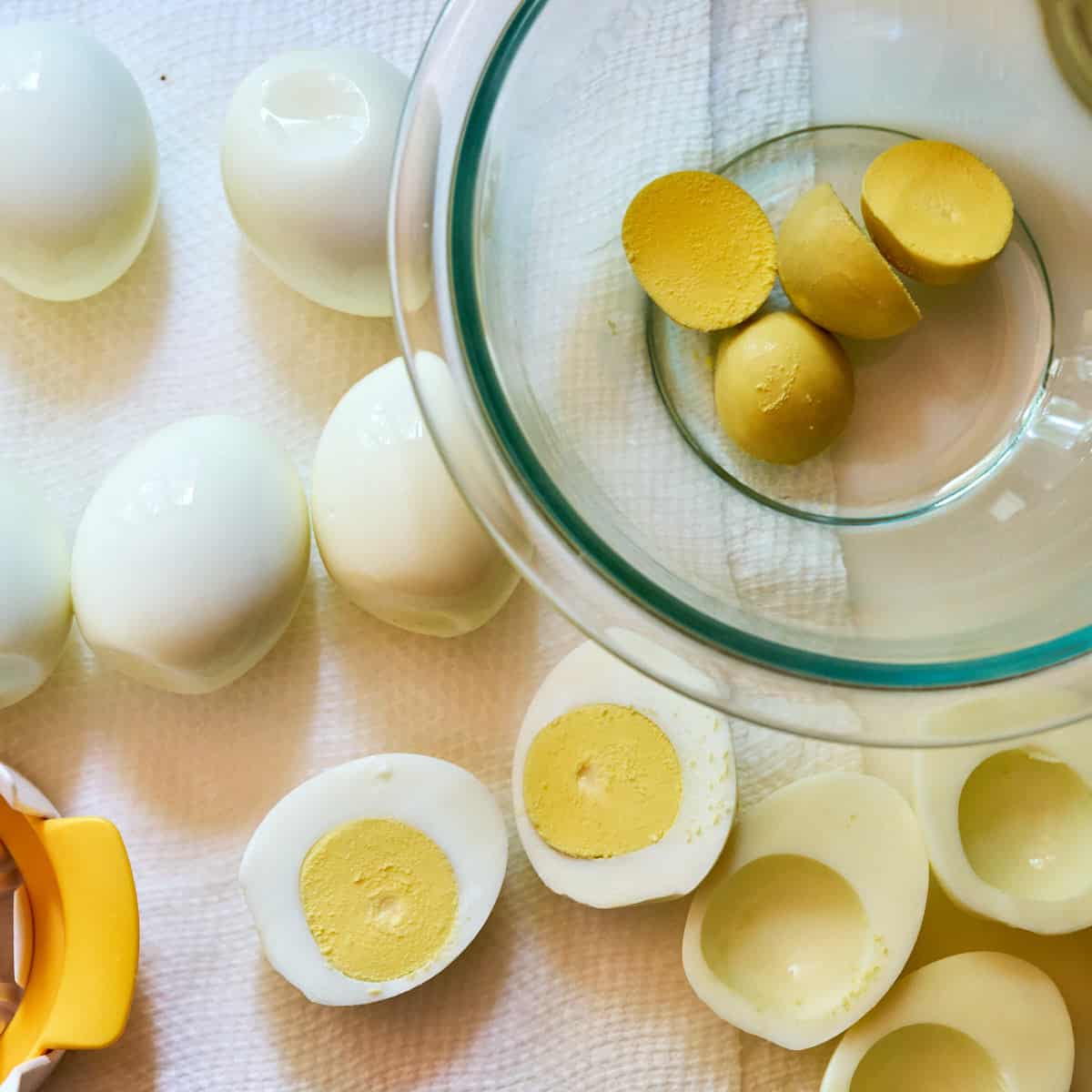 Hard-boiled eggs, split eggs, and yolks removed for deviled eggs