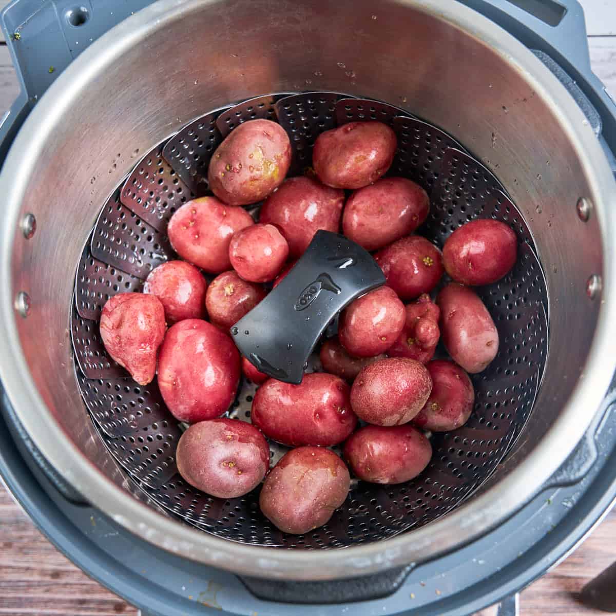 Baby potatoes in a vegetable steamer basket in an Instant Pot
