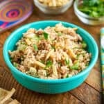 A bowl of Instant Pot Lamb Rice with parsley and almonds