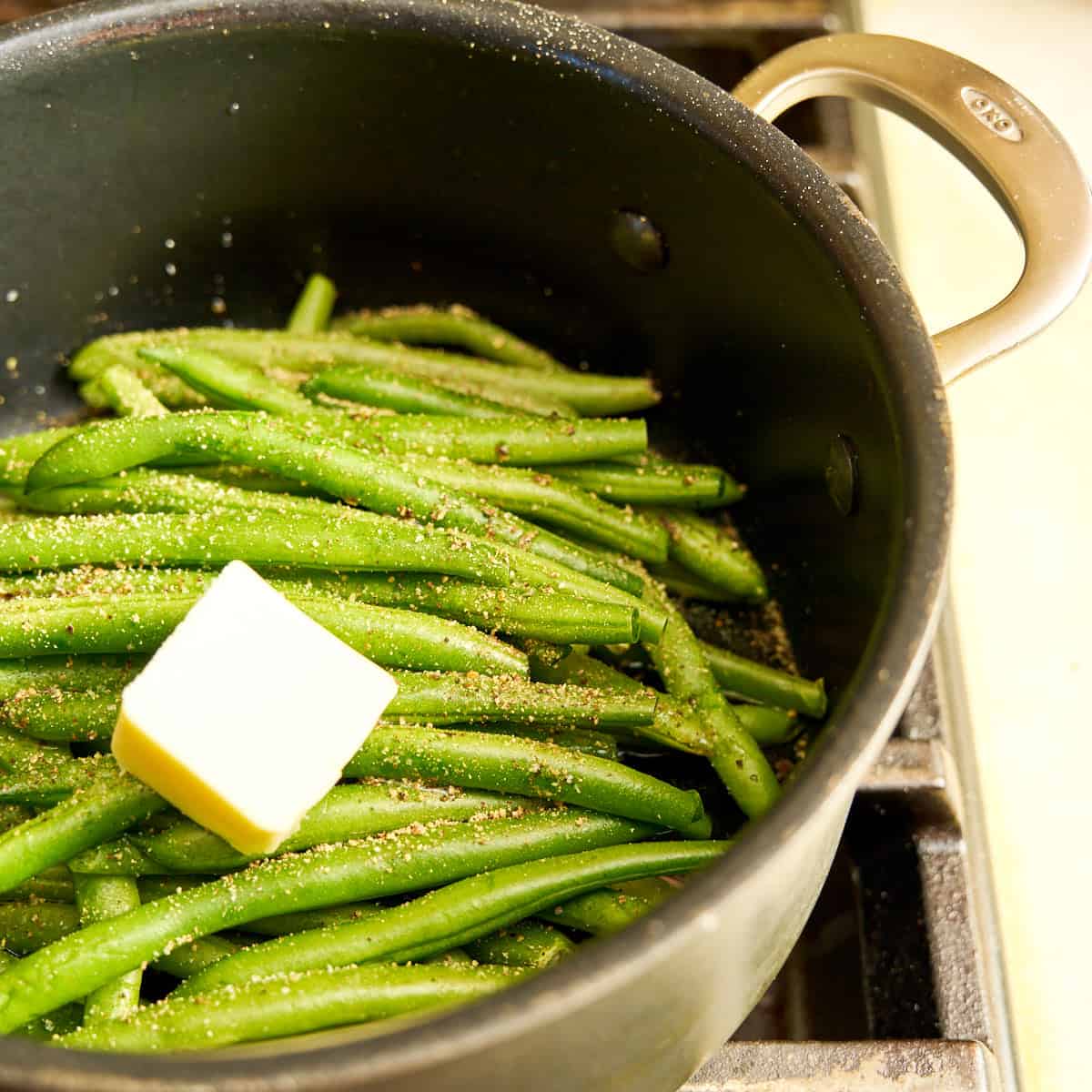 Beans, butter, water, salt, and pepper in the pot