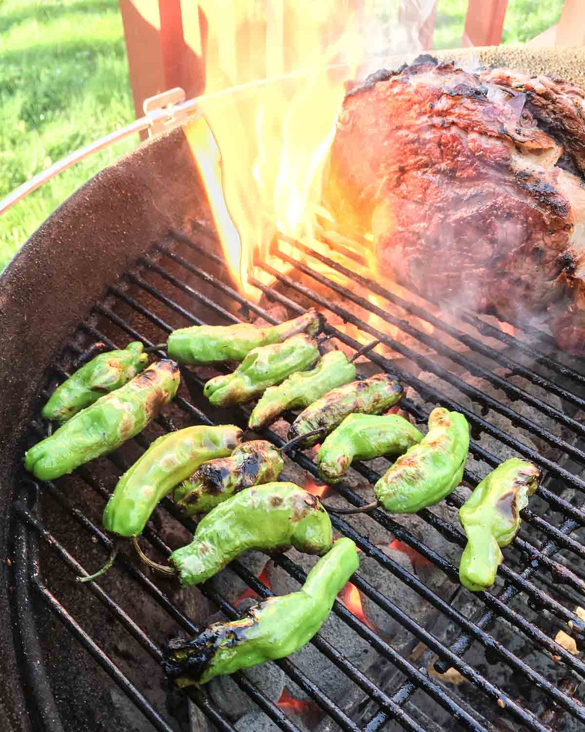 Shishito peppers blistering on the grill (with ribeye flareup in background)