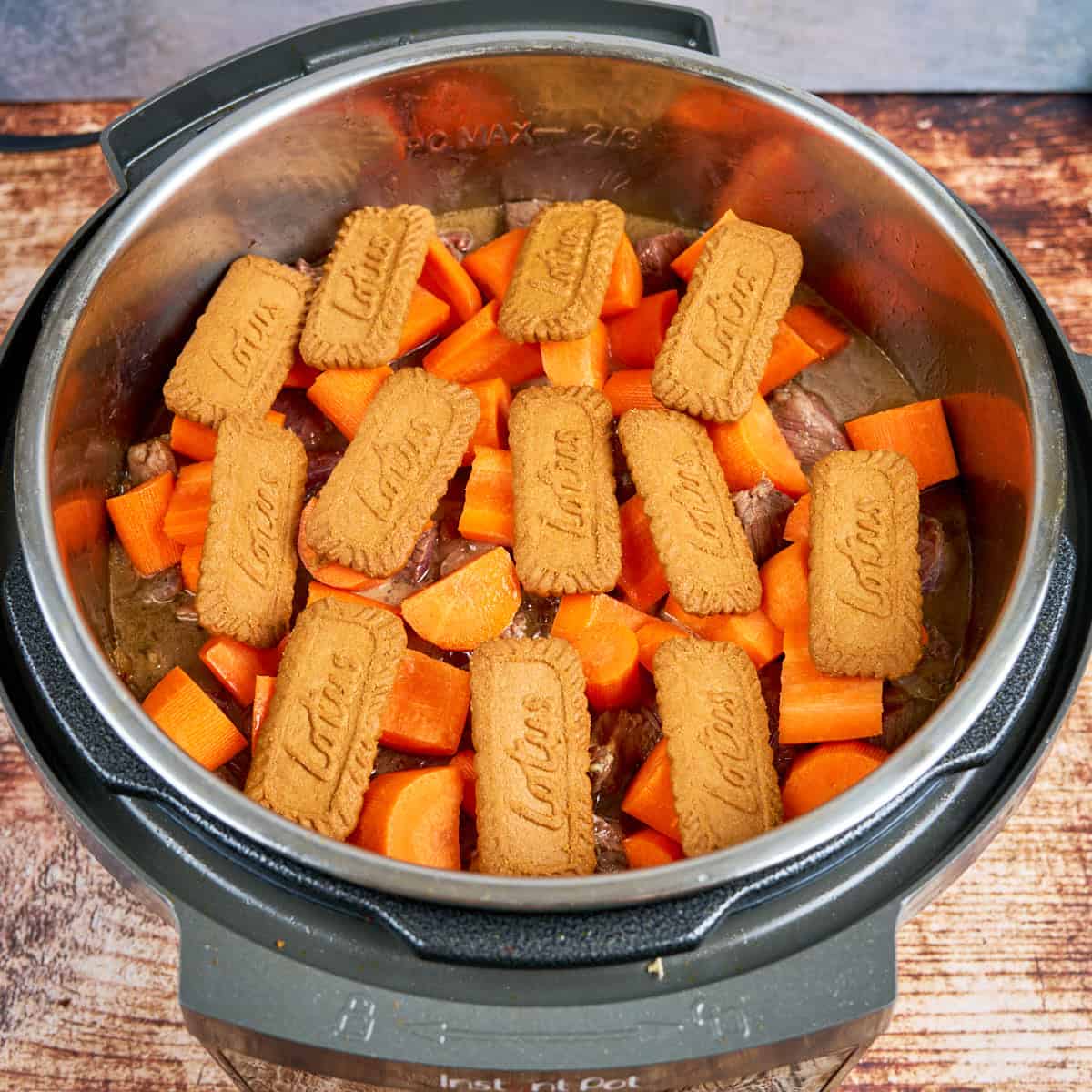 Everything in the pot with a layer of Biscoff cookies on top