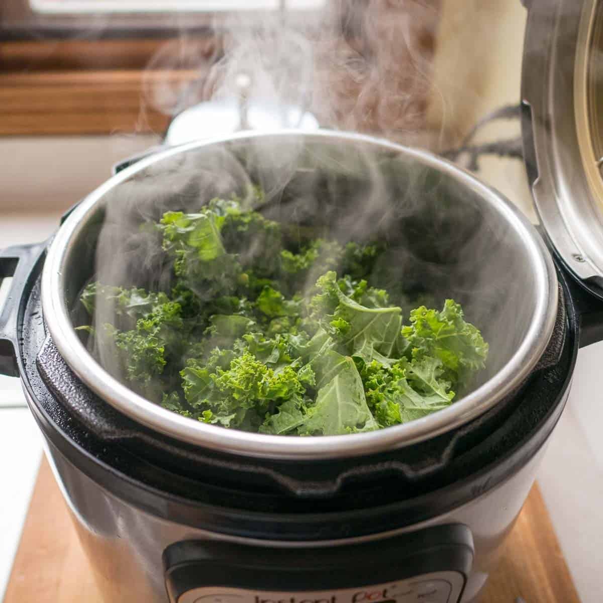 Packing the kale into the Instant Pot