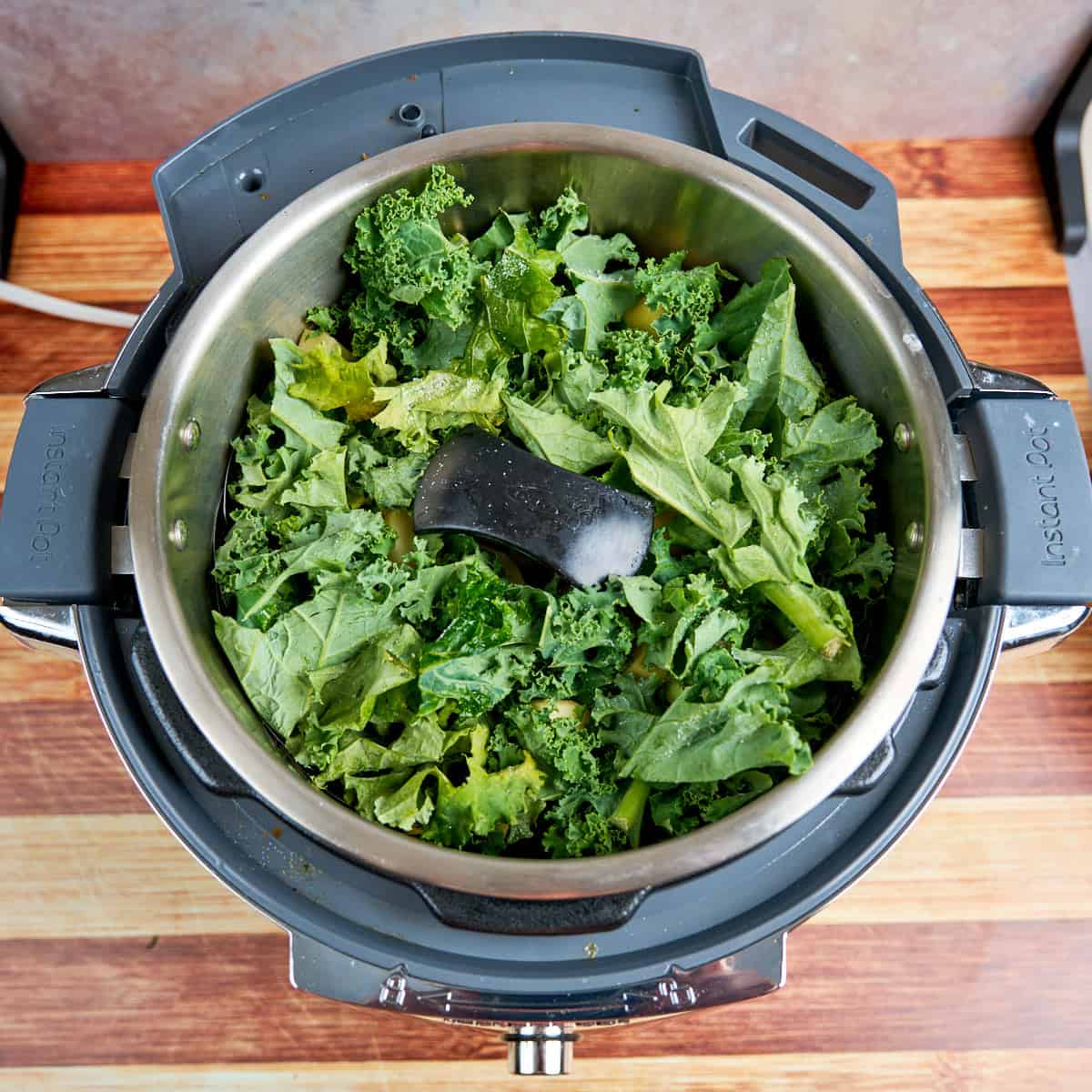 Kale and potatoes in the steamer basket in an Instant Pot