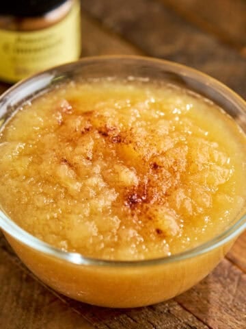 A bowl of Instant Pot Applesauce with some cinnamon sprinkled on it