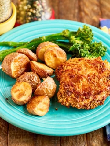 A plate of air fryer breaded chicken thighs and potatoes
