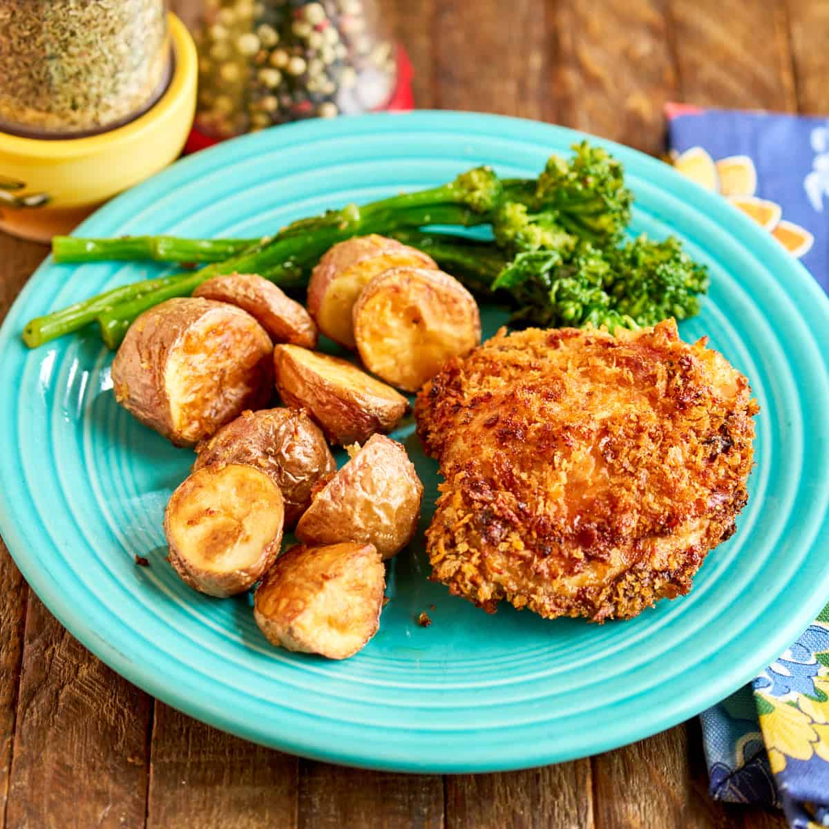 A plate of air fryer breaded chicken thighs and potatoes