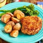 A plate of air fryer breaded chicken thighs and potatoes