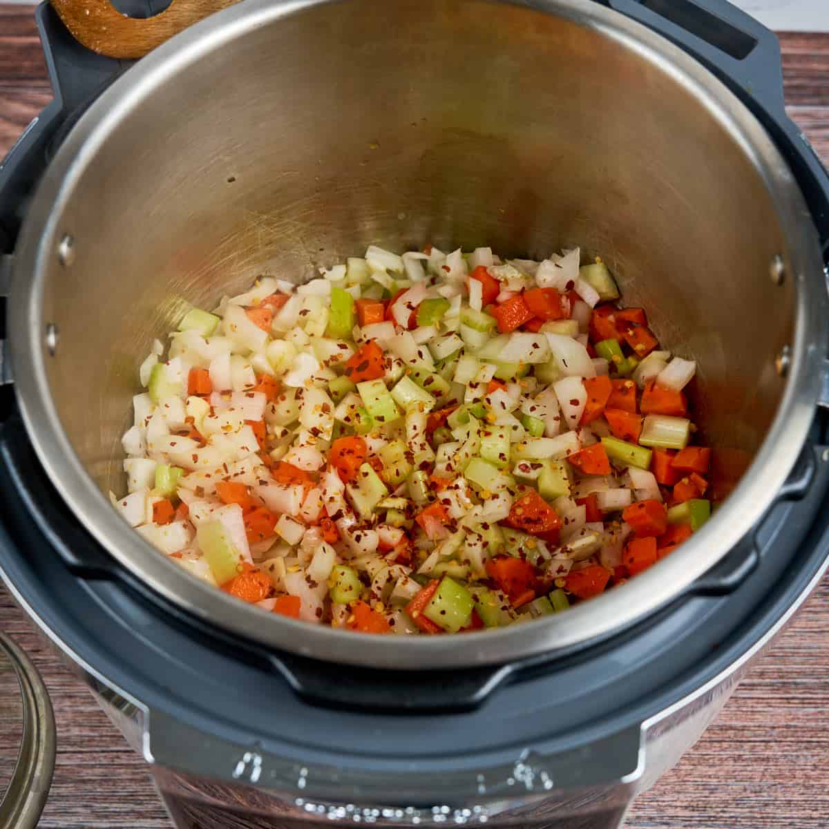 Sauteing onions, celery, carrots, garlic, and red pepper flakes in an Instant Pot