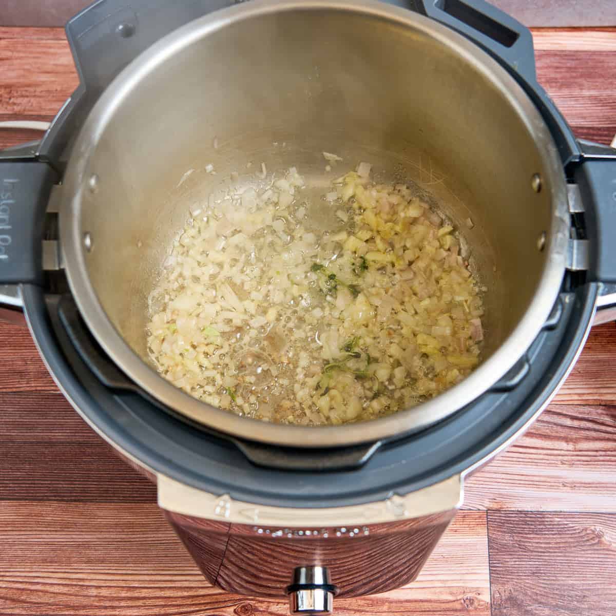 Sauteing the shallot, garlic, and thyme sprigs