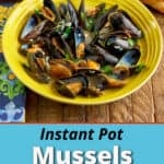 A bowl of Instant Pot Mussels with a loaf of bread and an Instant Pot in the background