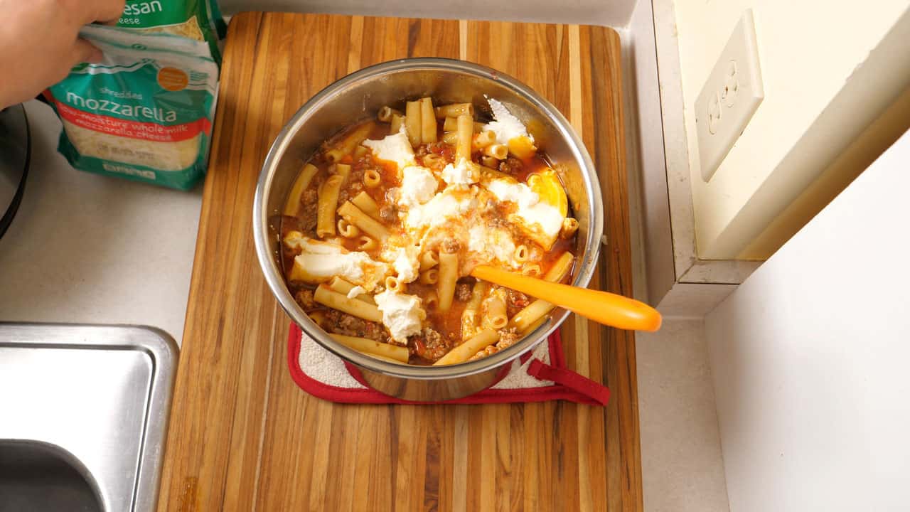 Adding the cheese to the pot