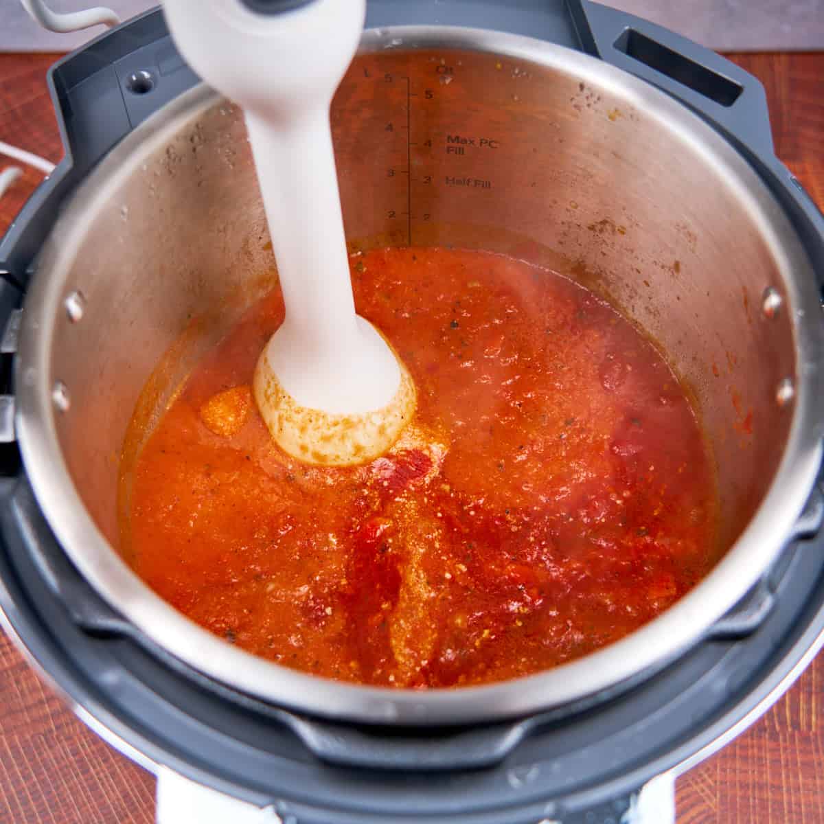 Blending the soup in the pot with an immersion blender