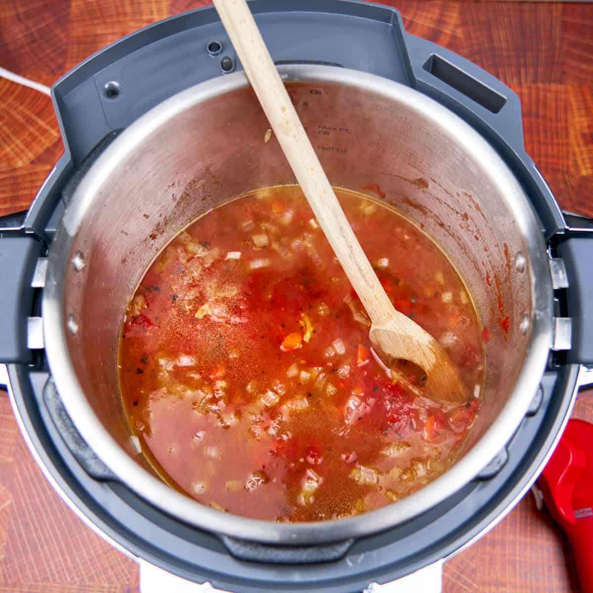 Add the broth and tomatoes to the pot