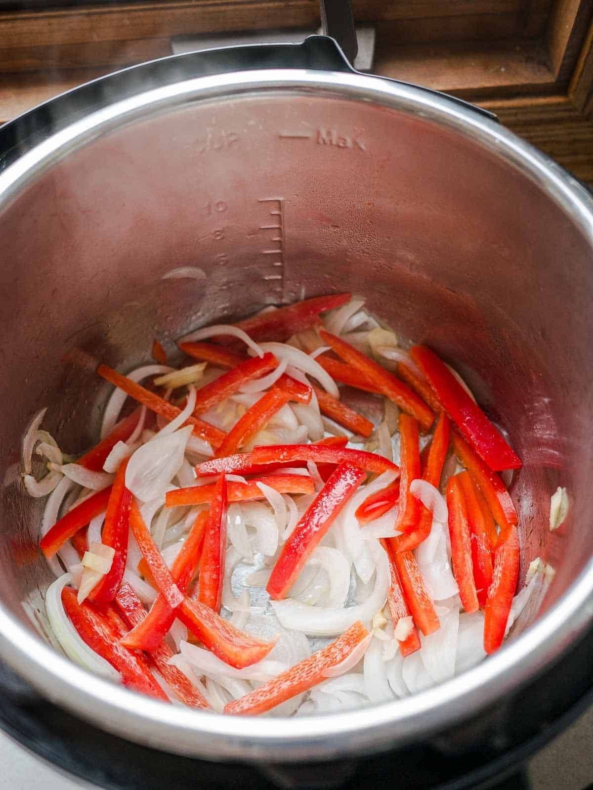 Sautéing onions, red bell peppers, garlic, and ginger in an Instant Pot