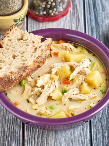 A bowl of Instant Pot Chicken Pot Pie soup with a slice of bread