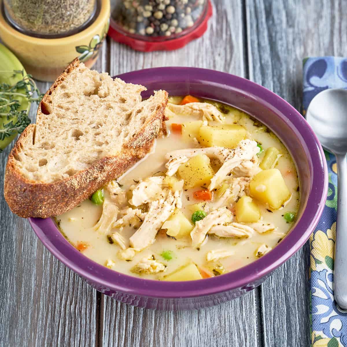 A bowl of Instant Pot Chicken Pot Pie soup with a slice of bread