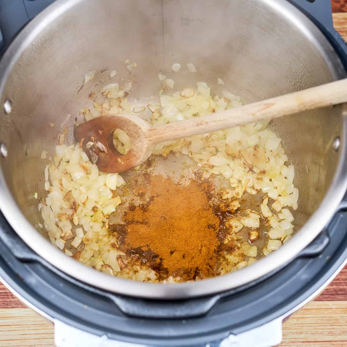 Sauté the onions, toast the garlic, ginger, and spices