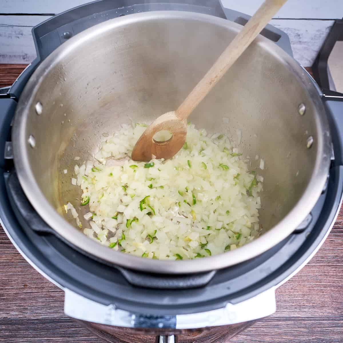 Onion, jalapeños, and garlic sautéing in the pot