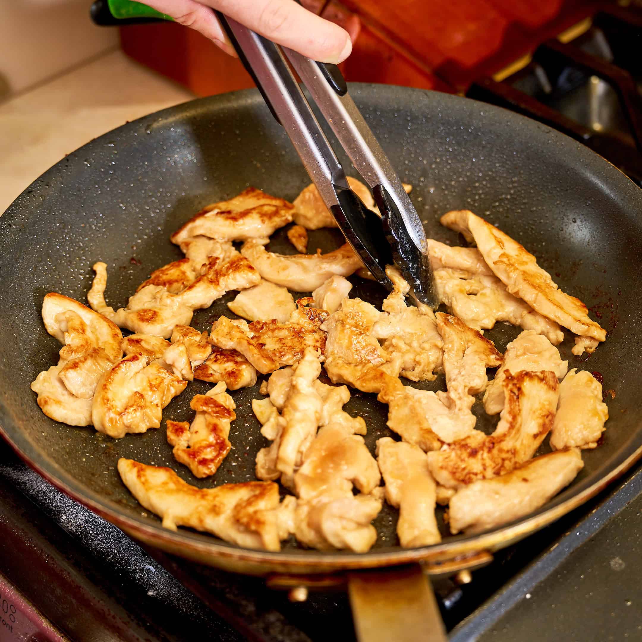Stir frying a batch of the chicken