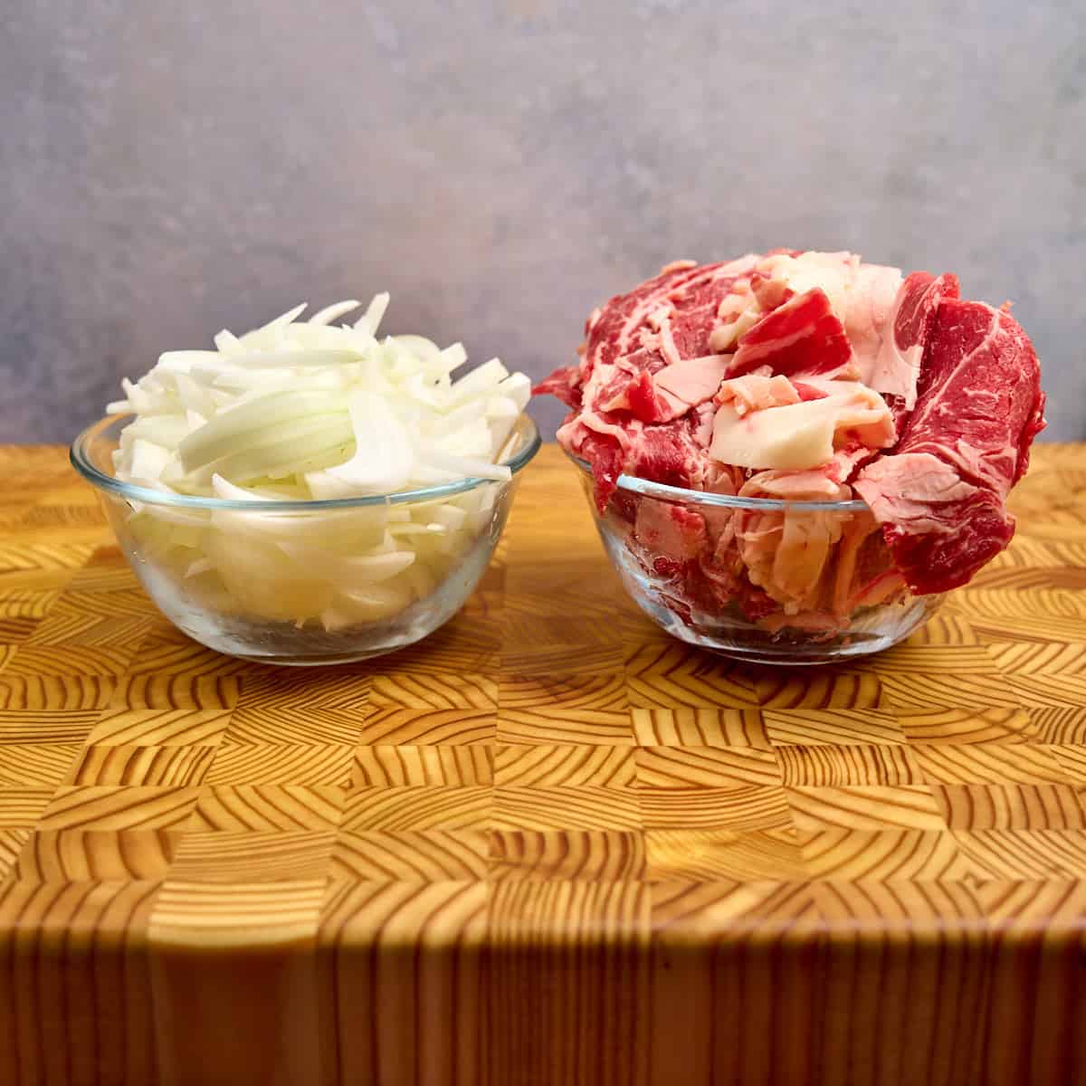 Sliced onions and beef ready to cook