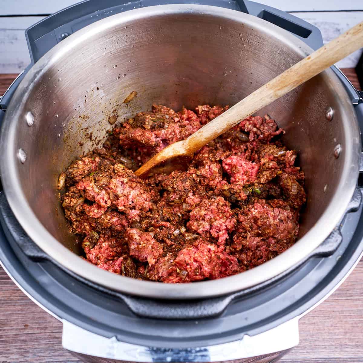 Stirring and breaking up the elk in the pot