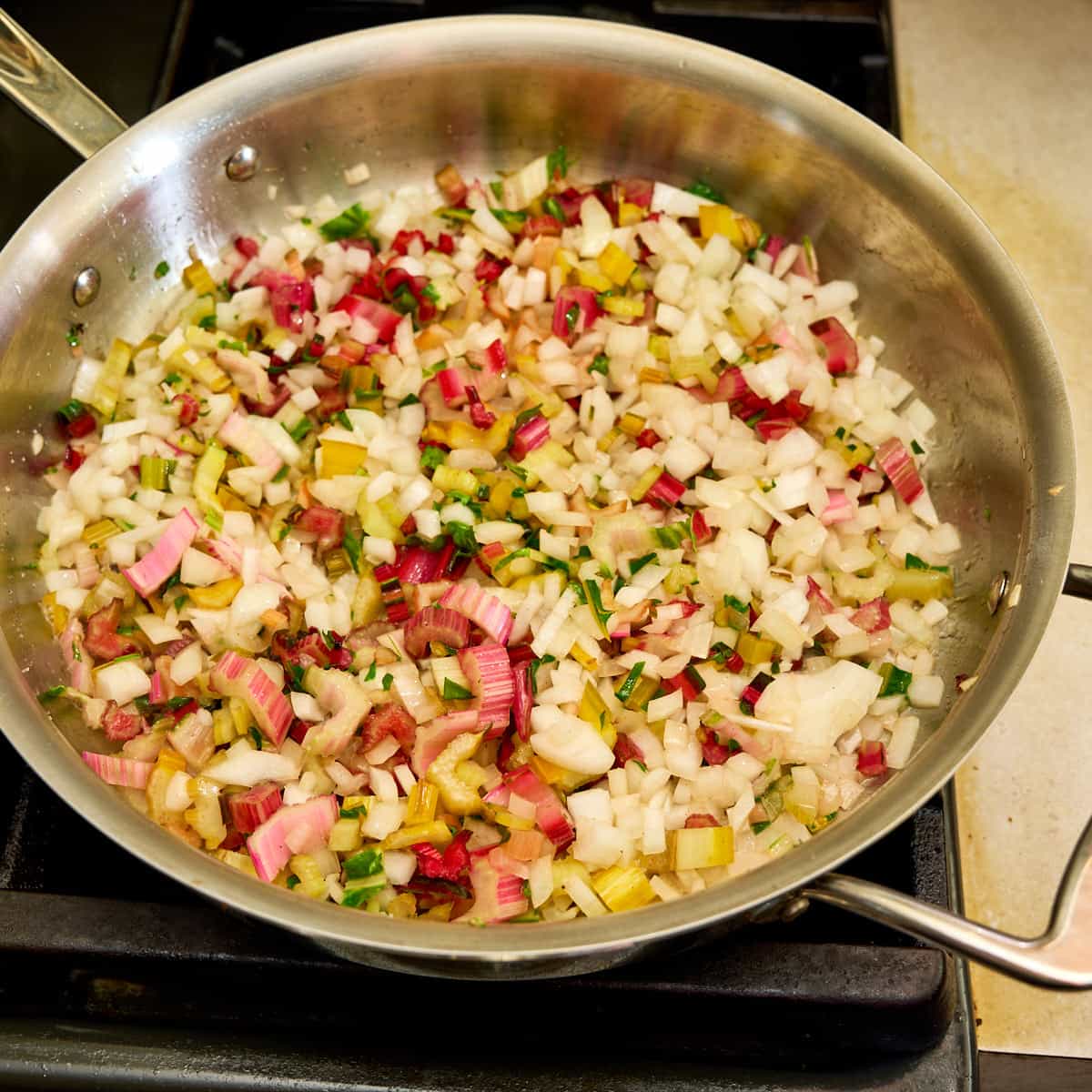 Onions and chard stems in the pan