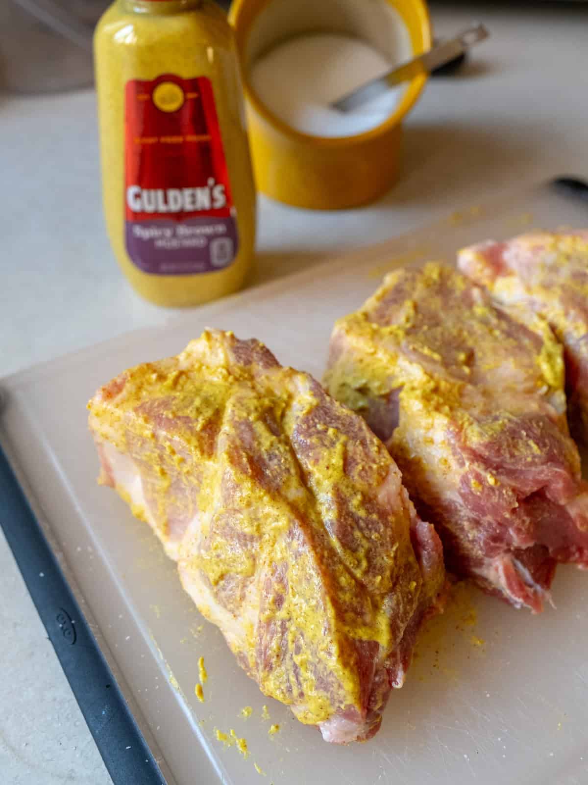 Pork roast cut into strips and rubbed with mustard