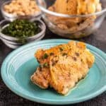 A chicken thigh sprinkled with herbs