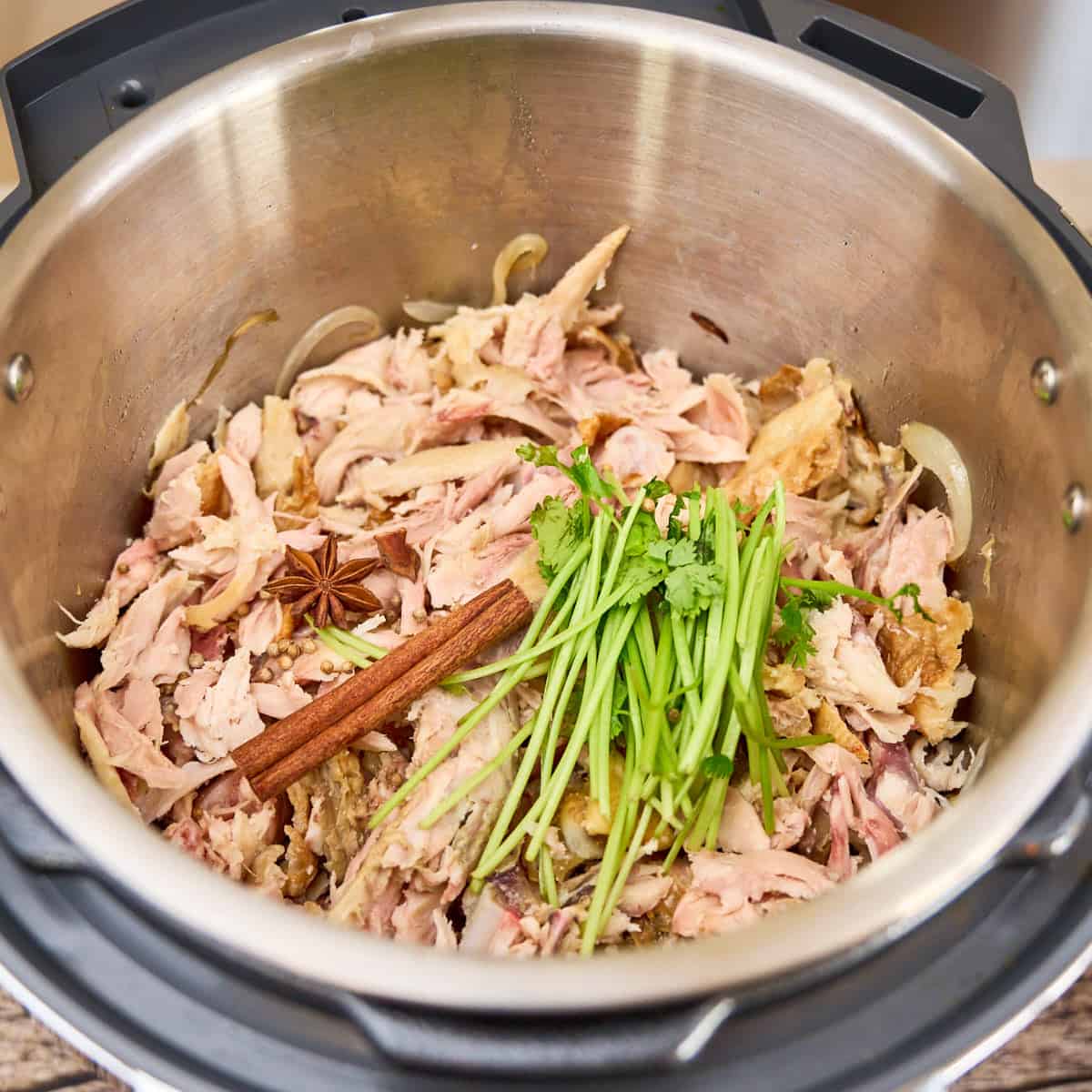 Shredded chicken in the pot for broth